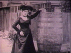 Still from experimental documentary film: historical photo of Annie Edson Taylor by her barrel - one of the early daredevils and stunters of Niagara Falls