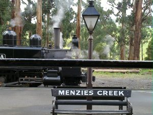 Steam engine, lamppost, and bench