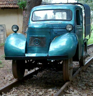 old blue car retrofitted with rail wheels