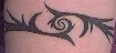 Thumbnail image of a tattoo--a tribal-style black armband, with 
spirals.