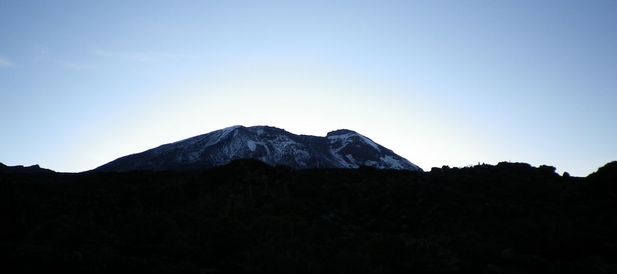 Kibo with the sun rising behind it